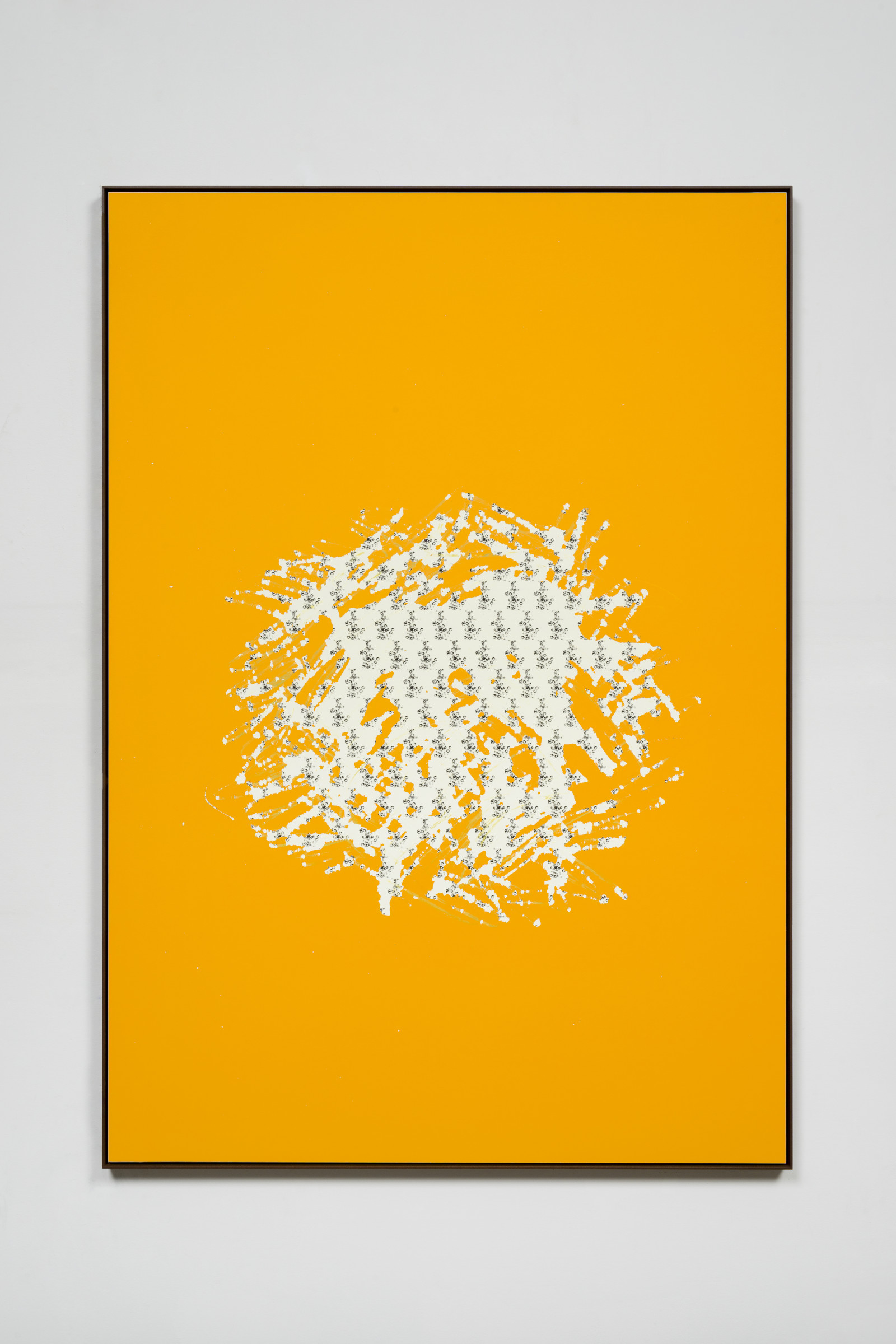 A framed work of an image covered in bright orange scratch off ink that has been scratched away in the middle in a roughly circular pattern revealing a black and white repeating pattern of champagne bubbles